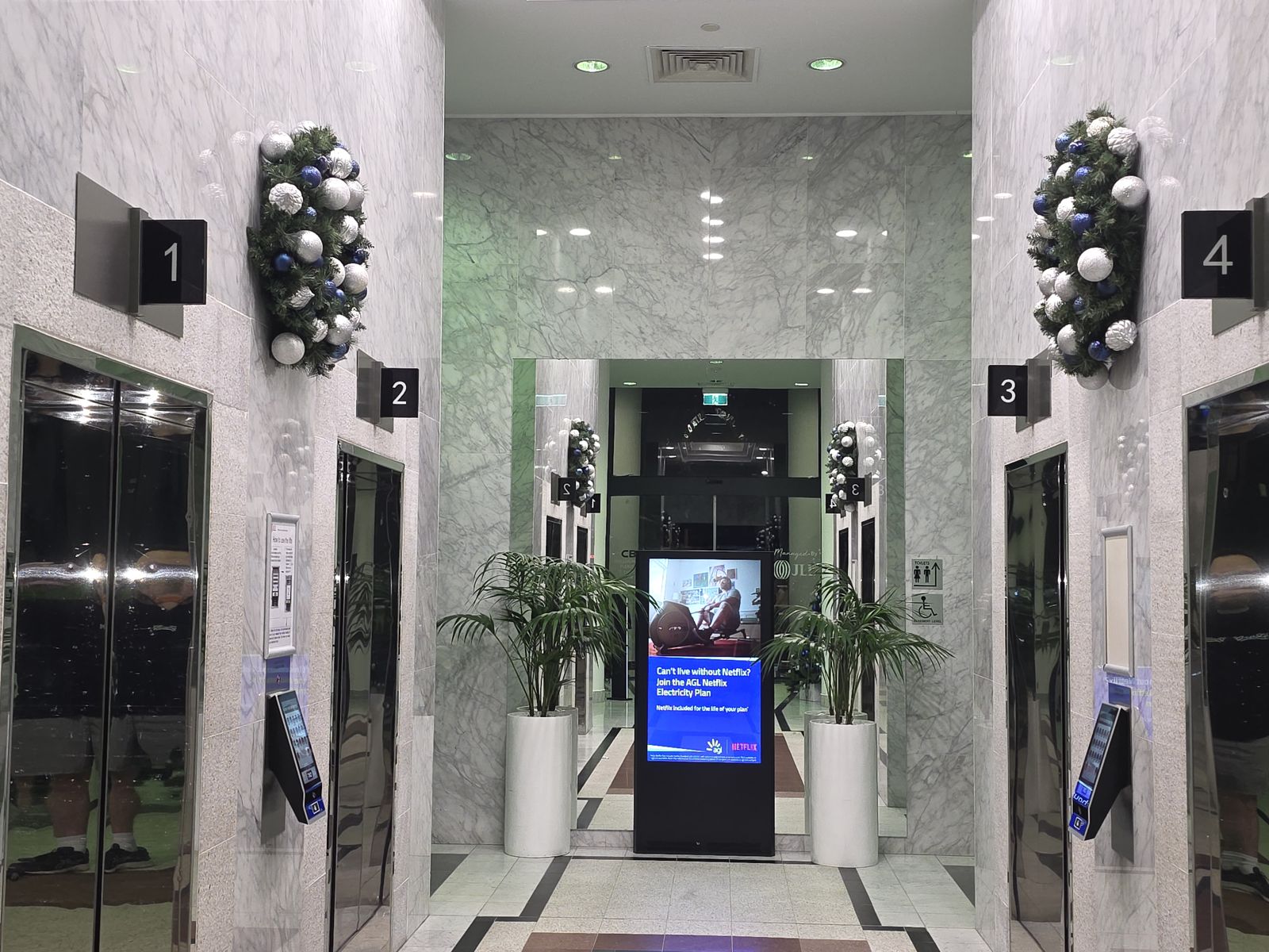 Lift lobby festive theming with hanging baubles in a commercial building