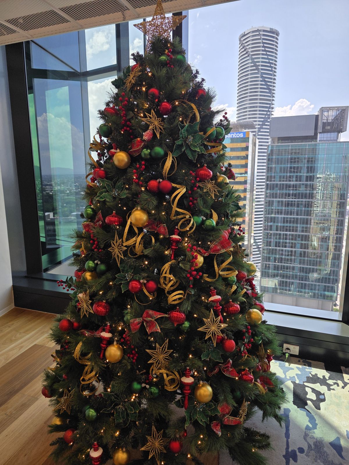 Red and gold tree in a modern workplace