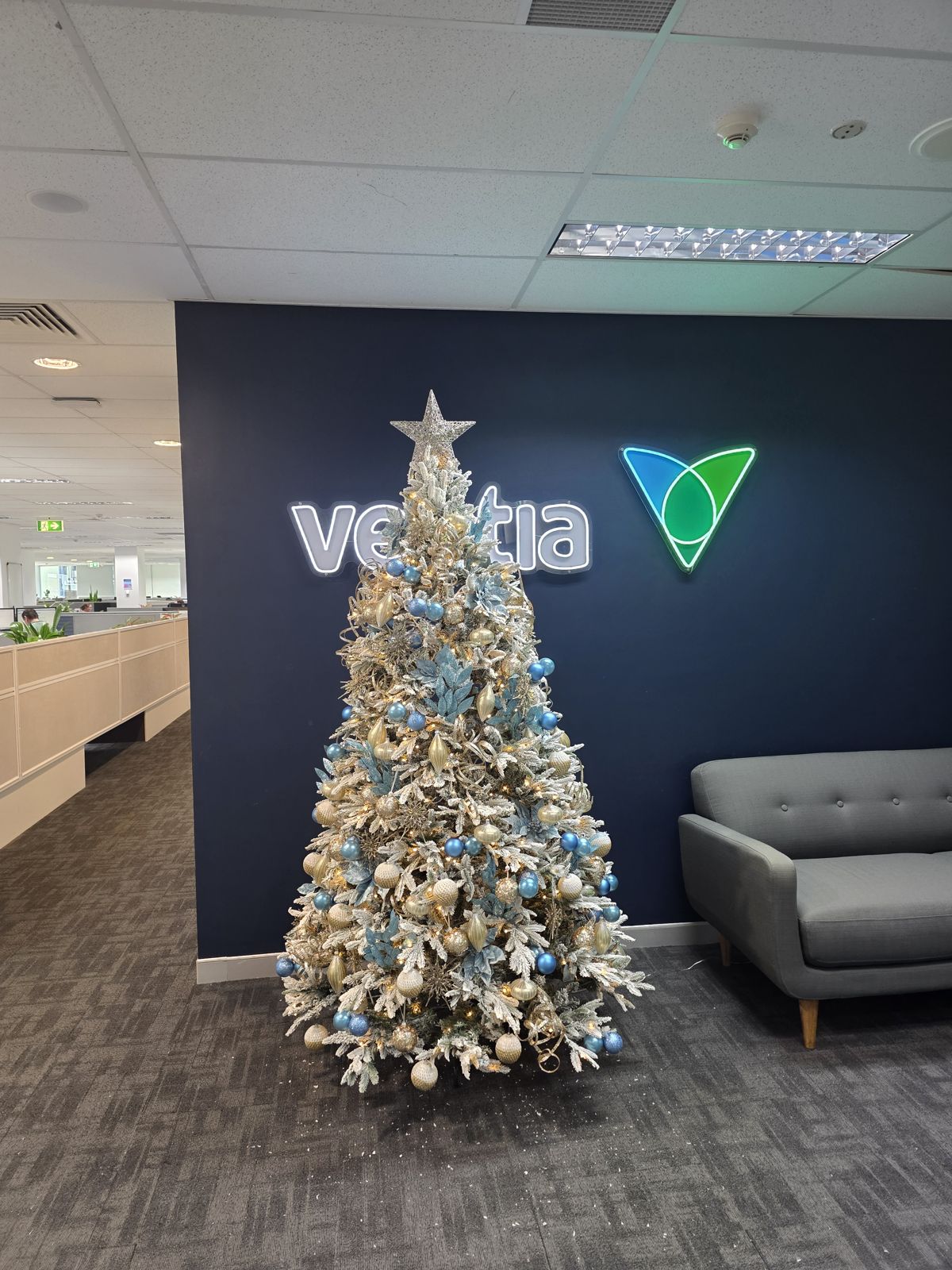 White and gold flocked tree in a corporate office